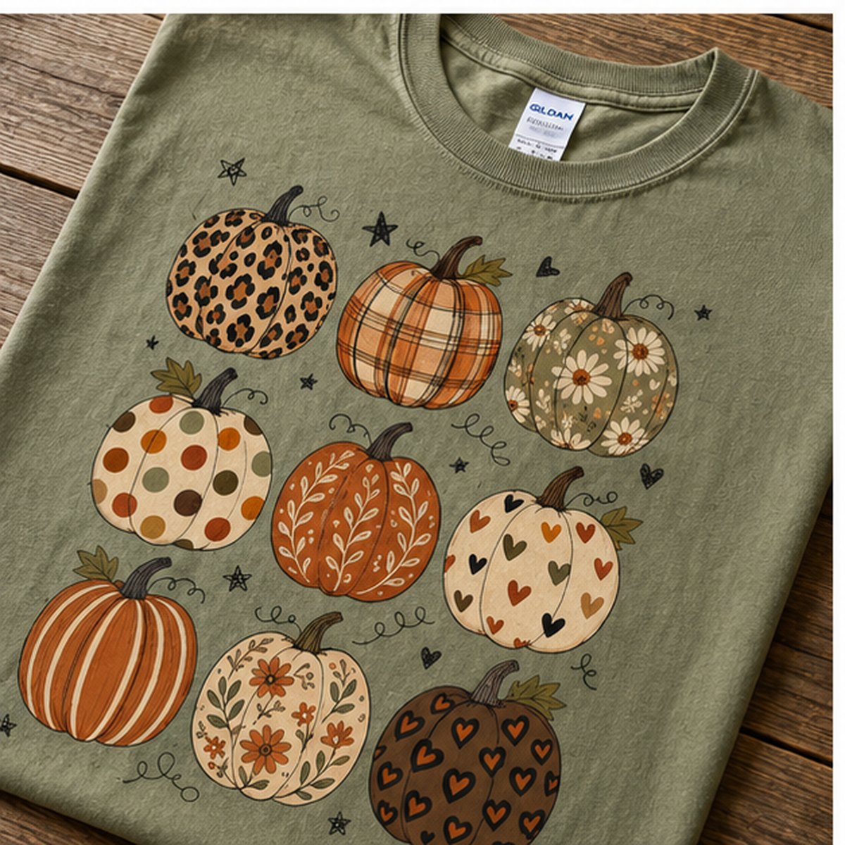 Close-up of the patchwork pumpkin grid graphic showing leopard print, plaid, floral, and polka dot pumpkin illustrations on sage green cotton.