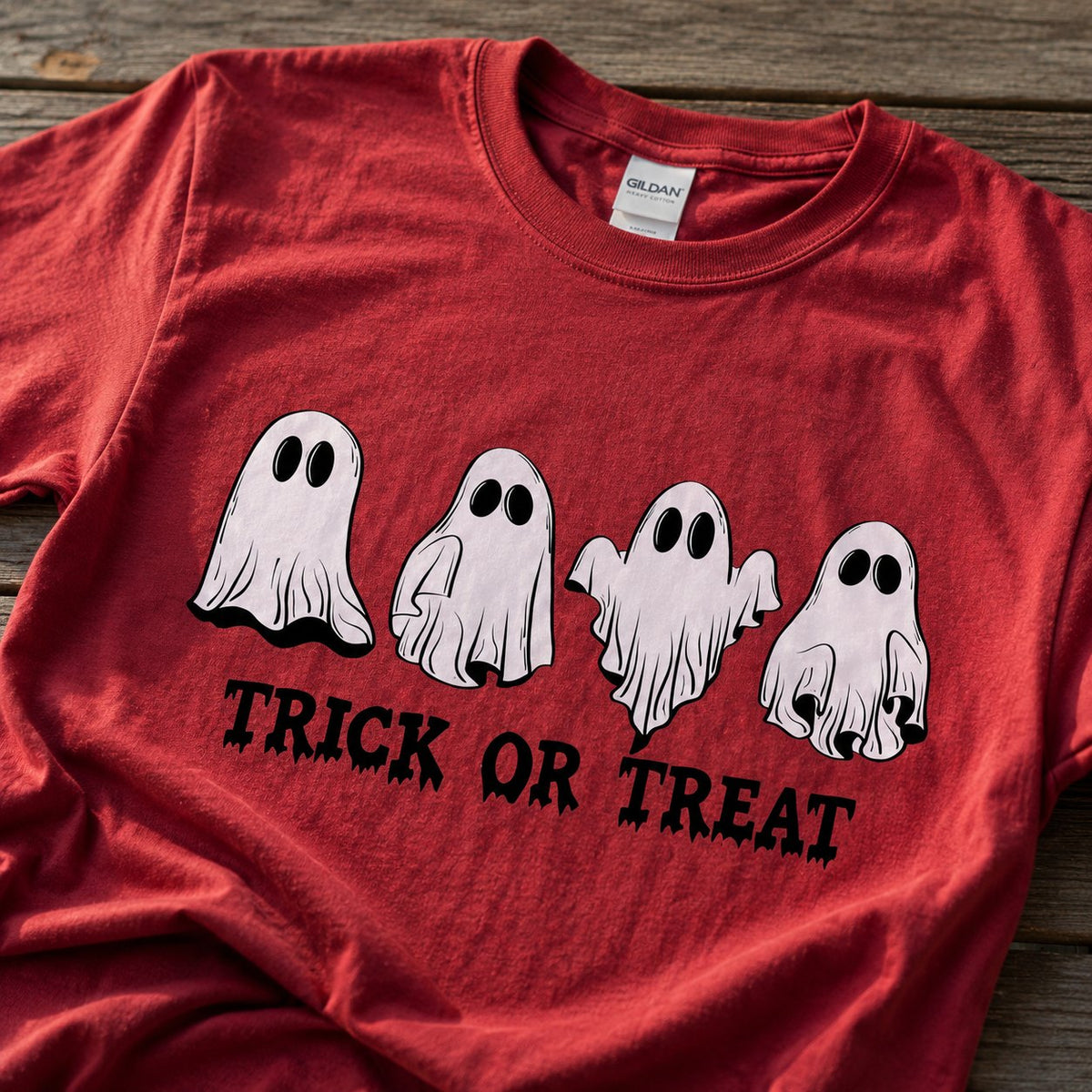 Close-up of the four hand-drawn ghosts and dripping "TRICK OR TREAT" text printed on red cotton fabric.